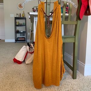 Gold tank top with maroon and gold jewelry